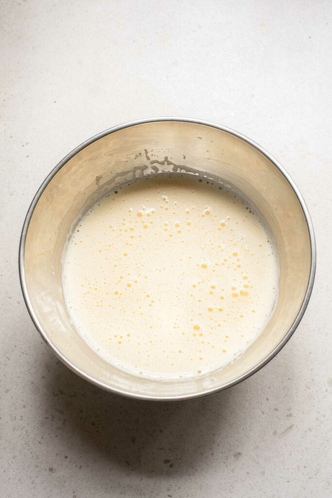 A bowl of milk on a white surface, with a touch of elegance resembling champagne.