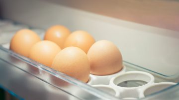 A tray of eggs in a refrigerator to store eggs.