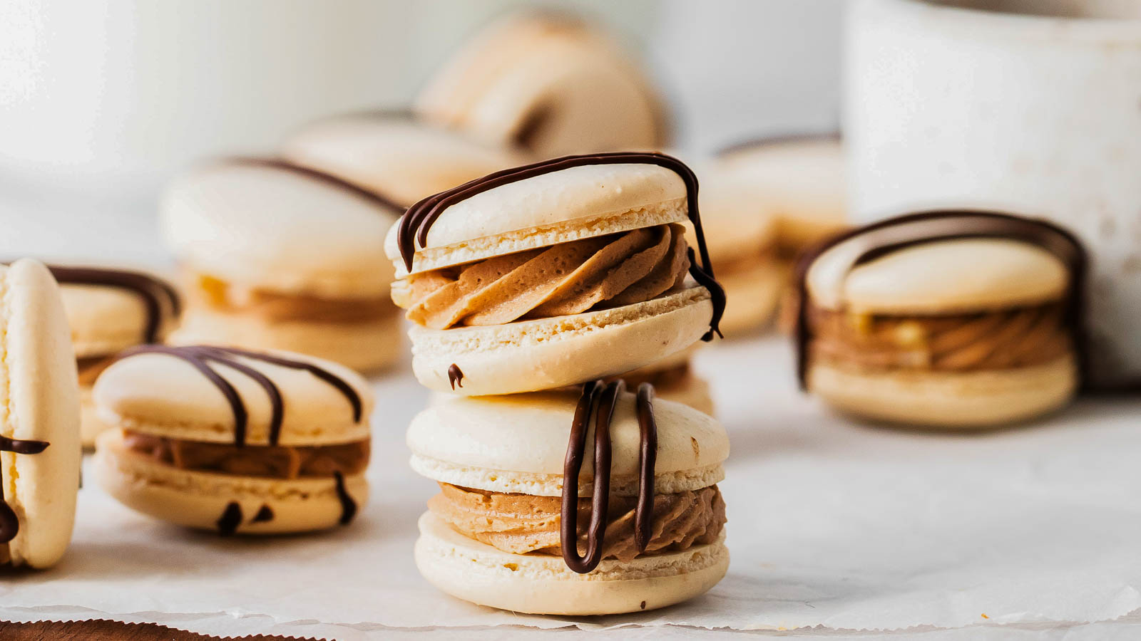 German chocolate macarons with chocolate ganache drizzle.