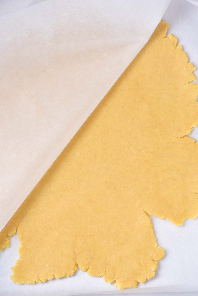 A piece of yellow dough on a piece of paper.