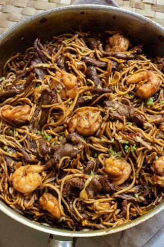 A bowl of Hokkien noodles with shrimp and stir-fried beef.