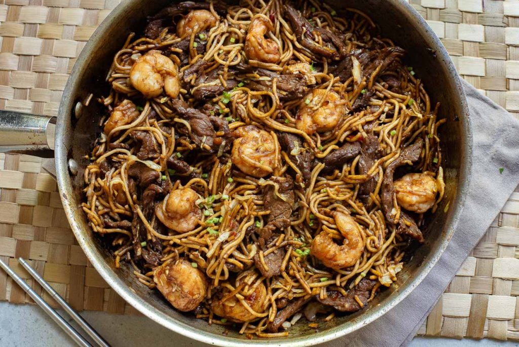 A pan of stir-fried Hokkien noodles with beef and shrimp.