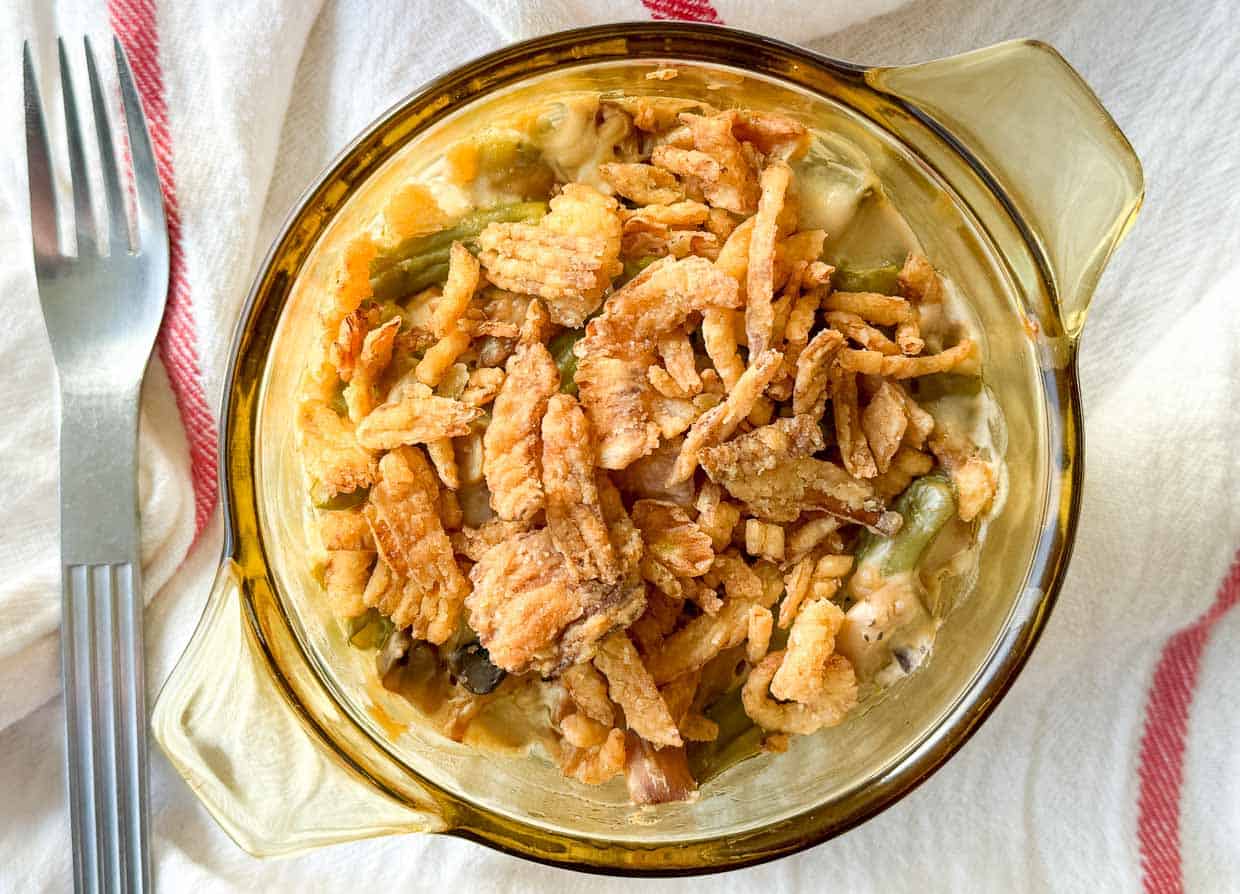 Crispy onions added to the casserole with a fork on the side.