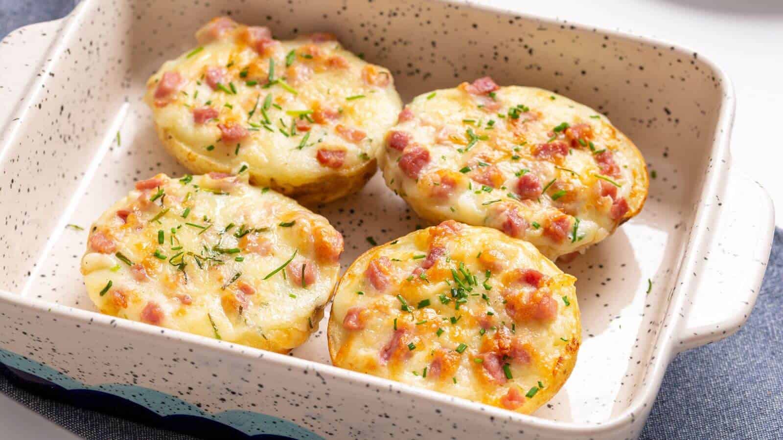 Four twice baked potatoes in a small baking dish.