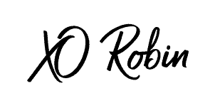 The image shows the handwritten words “XO Robin” in black script on a white background, elegantly capturing the signature style of Robin Donovan.